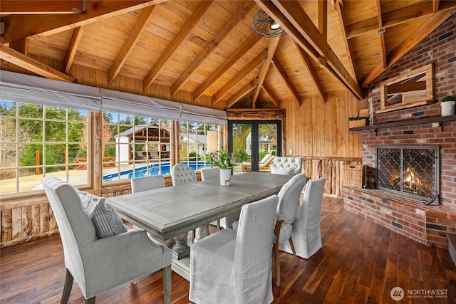 dining space featuring wooden ceiling, lofted ceiling with beams, wooden walls, and dark wood-type flooring