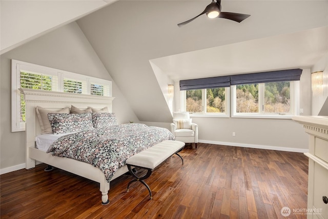 bedroom with lofted ceiling, a ceiling fan, wood finished floors, and baseboards