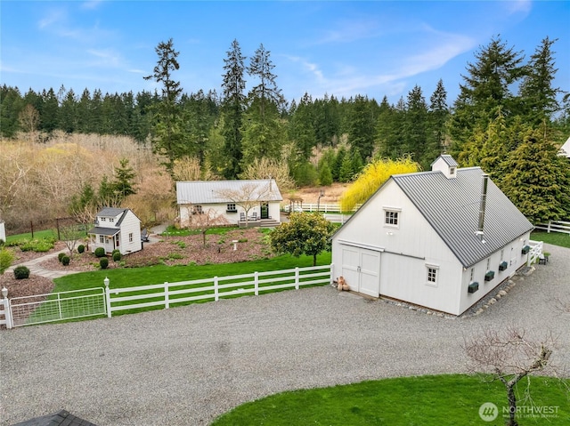 birds eye view of property with a view of trees