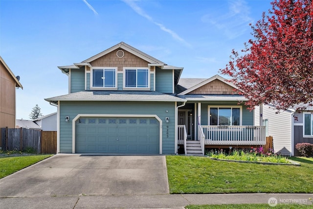 craftsman-style home with a porch, fence, a garage, driveway, and a front lawn