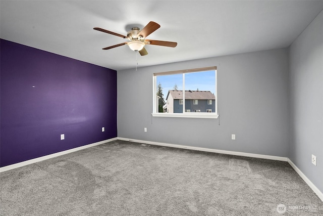 spare room with baseboards, a ceiling fan, and carpet