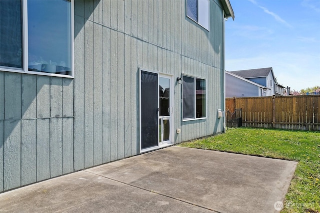 exterior space featuring fence, a lawn, and a patio