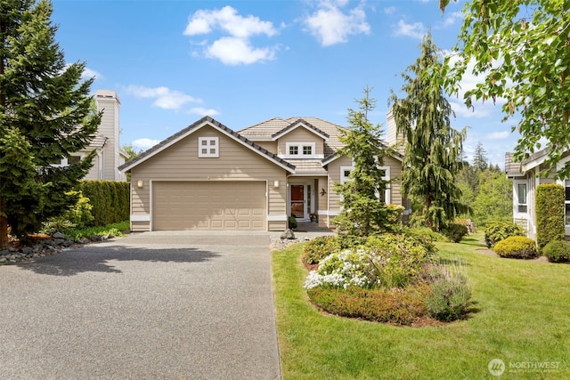 view of front of house with driveway, an attached garage, a front lawn, and a tiled roof