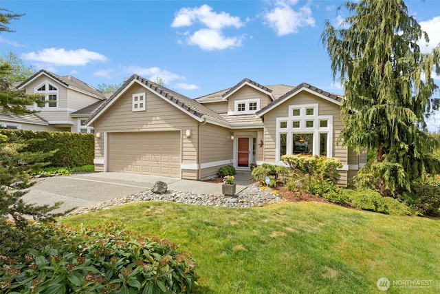 traditional-style house with a garage, a tile roof, a front yard, and driveway