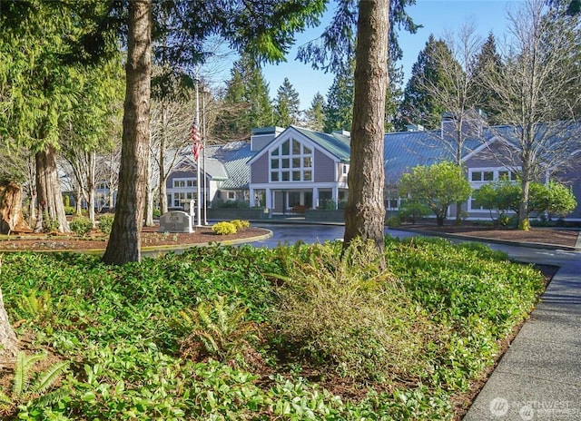 english style home featuring metal roof