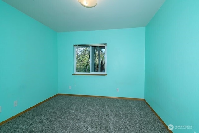 carpeted empty room with baseboards