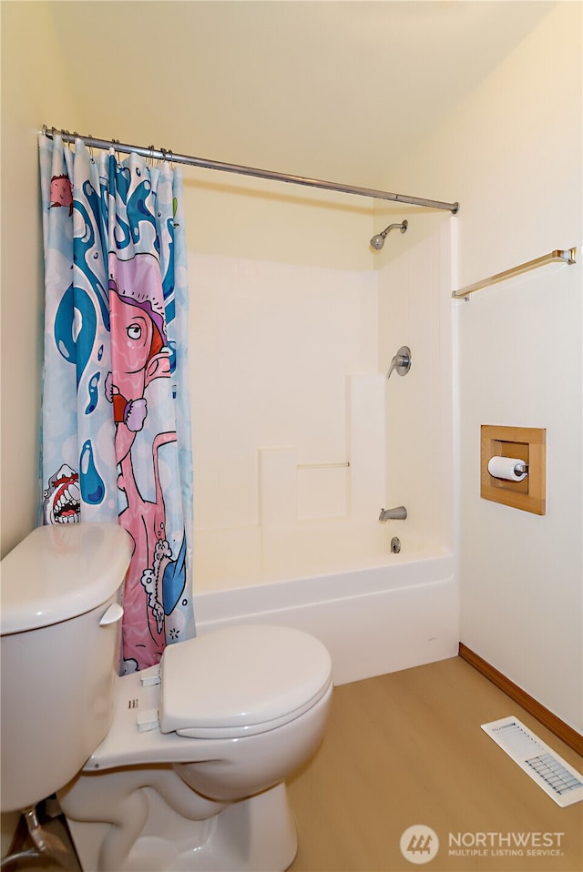 bathroom featuring visible vents, shower / bath combo, wood finished floors, and toilet