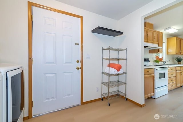 kitchen with white electric range oven, a sink, light countertops, baseboards, and under cabinet range hood