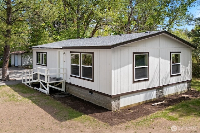 view of front of property with crawl space and a shingled roof