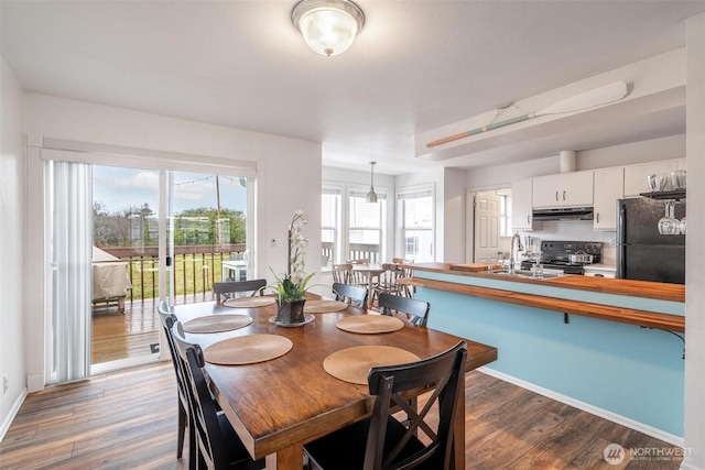 dining area with wood finished floors and baseboards