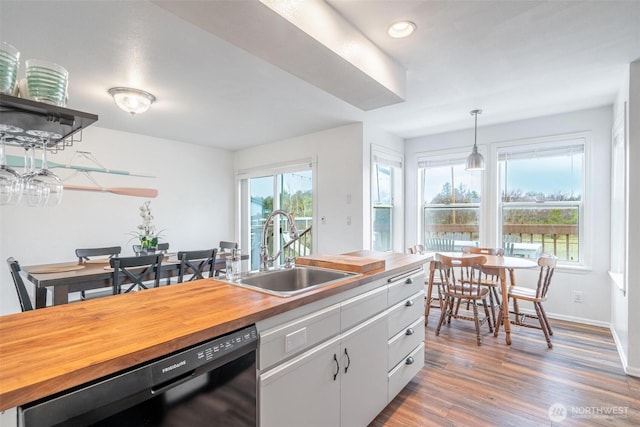 kitchen with white cabinetry, open shelves, a sink, wooden counters, and dishwasher