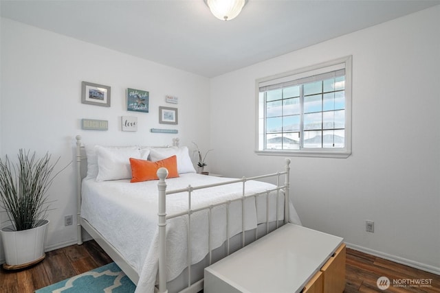 bedroom featuring baseboards and dark wood-type flooring