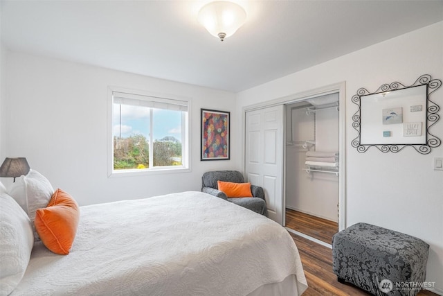 bedroom with wood finished floors and a closet