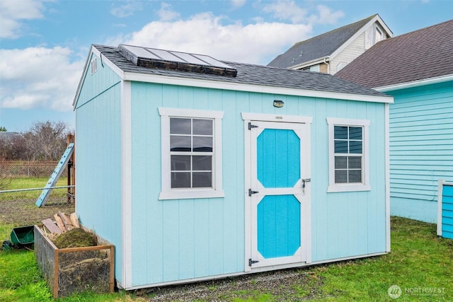 view of shed featuring fence