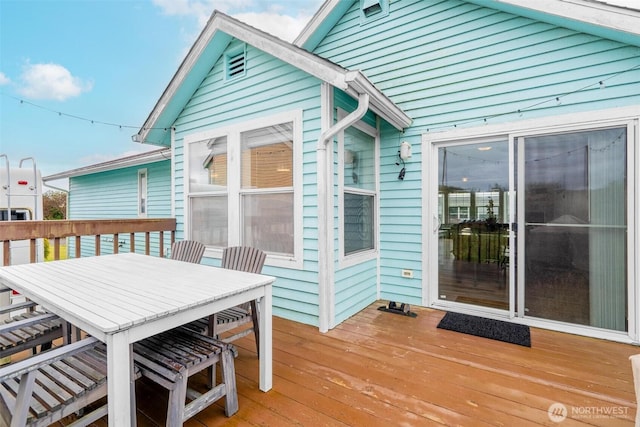 wooden deck with outdoor dining area