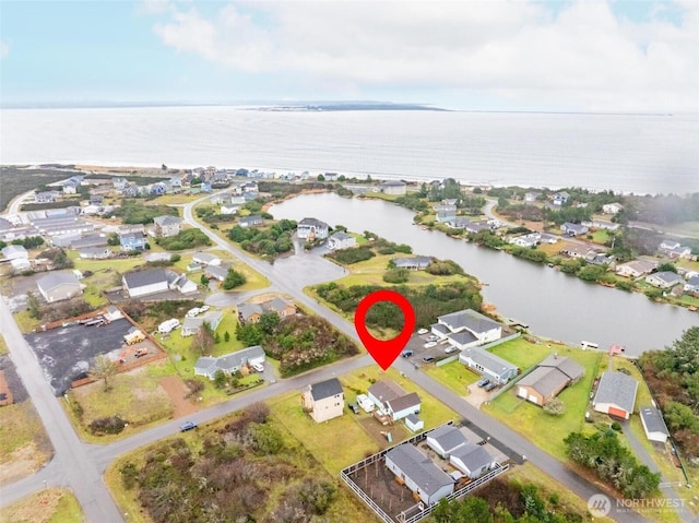 birds eye view of property with a residential view and a water view