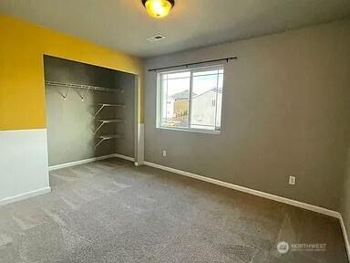 19020 25th Ave E, Tacoma, WA 98445 - unfurnished bedroom featuring carpet flooring, baseboards, and a closet