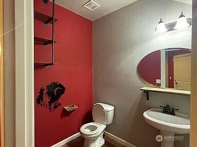19020 25th Ave E, Tacoma, WA 98445 - bathroom with toilet, baseboards, visible vents, and a sink