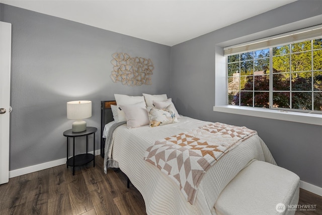 bedroom featuring wood finished floors and baseboards