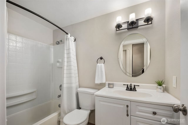 bathroom with shower / bath combination with curtain, vanity, and toilet