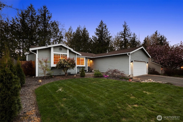 view of front of property with a front lawn, driveway, and a garage