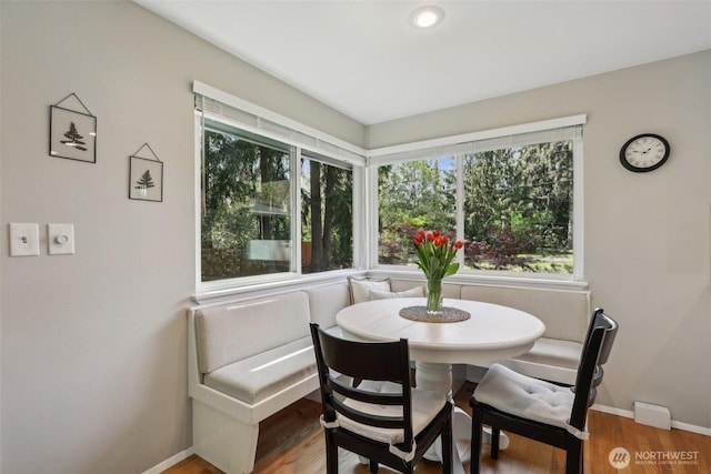 dining area featuring wood finished floors and baseboards