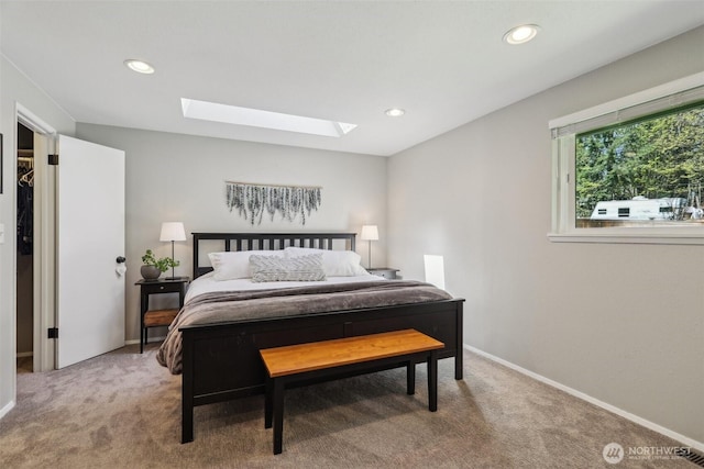 bedroom featuring baseboards, recessed lighting, a skylight, and light carpet