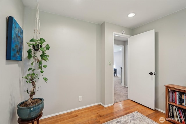 interior space with wood finished floors and baseboards