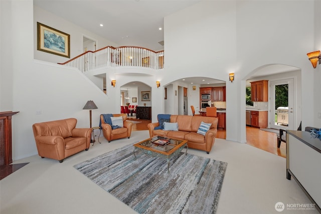 30941 37th Pl SW, Federal Way, WA 98023 - living area featuring light carpet, a high ceiling, arched walkways, and recessed lighting