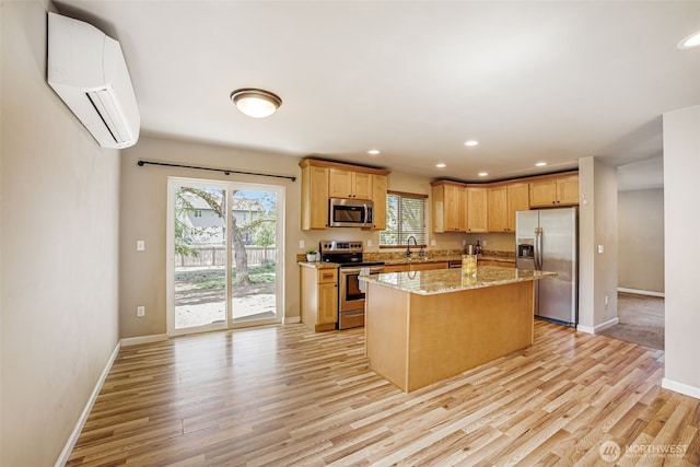 kitchen with stainless steel appliances, a wall mounted air conditioner, light wood-type flooring, a sink, and recessed lighting