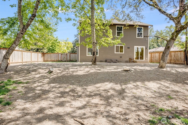 rear view of property featuring a fenced backyard and entry steps
