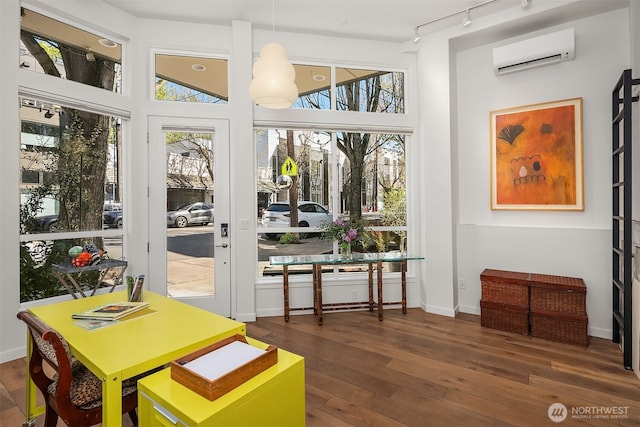 1121 34th Ave Unit A, Seattle, WA 98122 - entryway featuring rail lighting, a wall mounted AC, hardwood / wood-style flooring, and baseboards