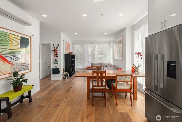 1121 34th Ave Unit A, Seattle, WA 98122 - dining space featuring a wall mounted air conditioner, light wood-style flooring, recessed lighting, and baseboards