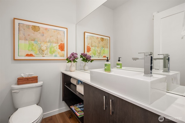1121 34th Ave Unit A, Seattle, WA 98122 - bathroom featuring baseboards, wood finished floors, toilet, and vanity