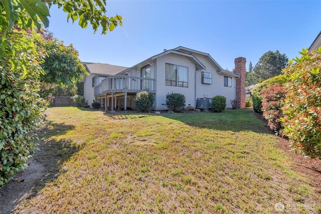 1823 19th Dr, Mukilteo, WA 98275 - rear view of property featuring a wooden deck, a lawn, and a chimney