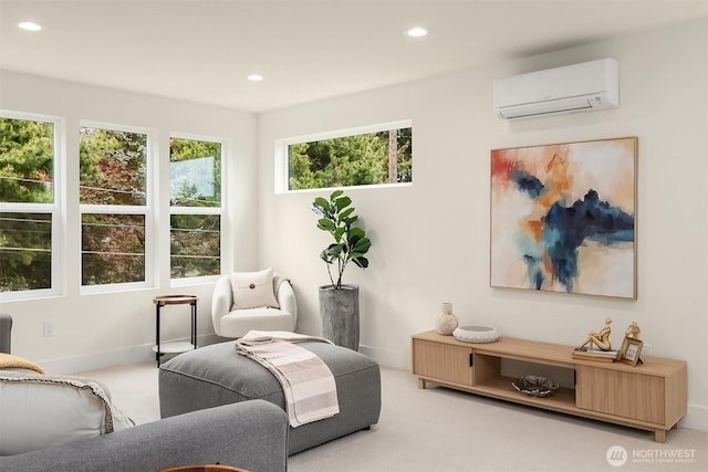 sitting room with recessed lighting, baseboards, a wall mounted AC, and carpet