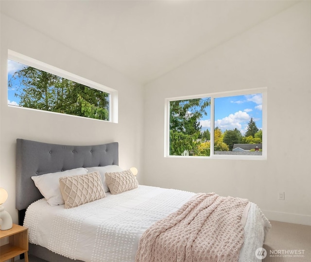 bedroom with carpet flooring and lofted ceiling