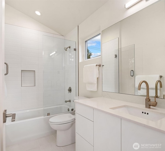 bathroom featuring tile patterned flooring, vanity, shower / bathtub combination, toilet, and vaulted ceiling