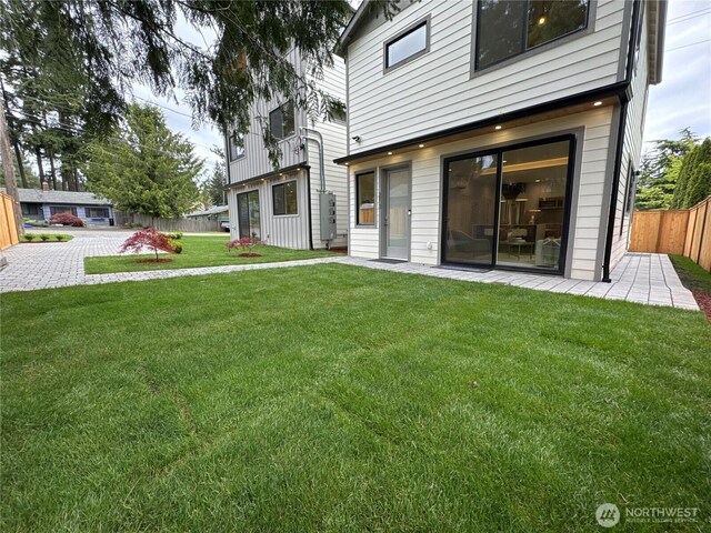 back of property with fence and a yard