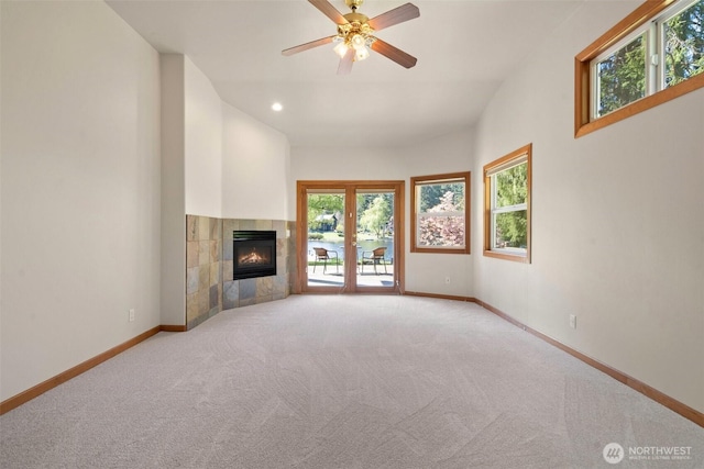 unfurnished living room with carpet flooring, baseboards, recessed lighting, a fireplace, and a ceiling fan
