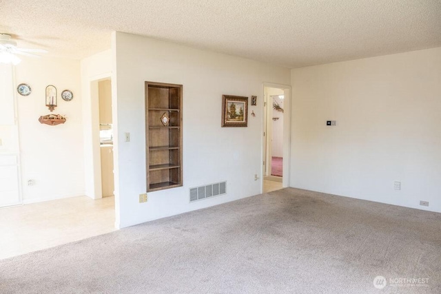 609 W Whitman Dr, College Place, WA 99324 - unfurnished room featuring carpet floors, ceiling fan, built in features, and a textured ceiling