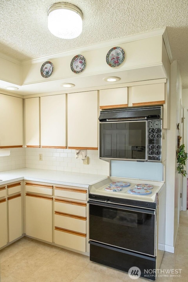 609 W Whitman Dr, College Place, WA 99324 - kitchen with black appliances, a textured ceiling, ornamental molding, light countertops, and decorative backsplash