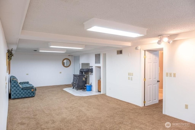609 W Whitman Dr, College Place, WA 99324 - unfurnished room featuring carpet floors, a wood stove, and a textured ceiling