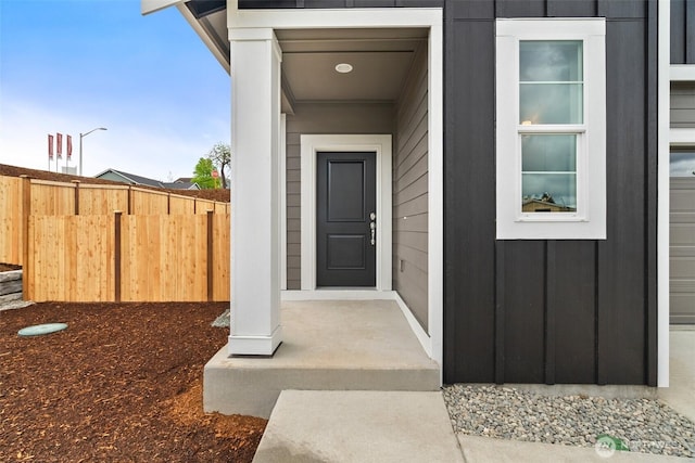 view of exterior entry with fence