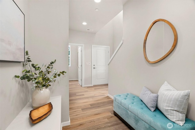 corridor with recessed lighting, baseboards, visible vents, and light wood-style flooring