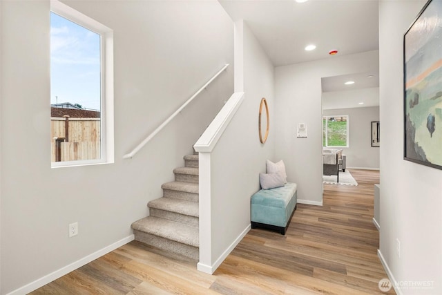stairs featuring recessed lighting, baseboards, and wood finished floors