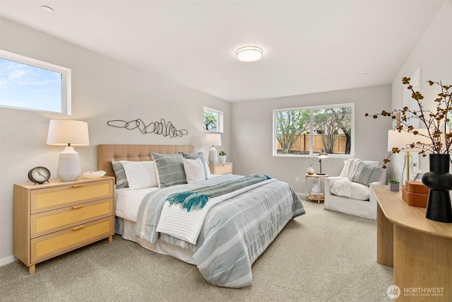 bedroom featuring baseboards and light carpet