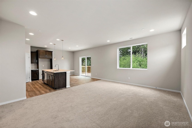 19504 15th Ave E, Spanaway, WA 98387 - unfurnished living room featuring light colored carpet and recessed lighting