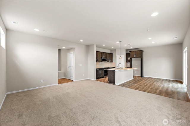 19504 15th Ave E, Spanaway, WA 98387 - unfurnished living room with recessed lighting and light carpet