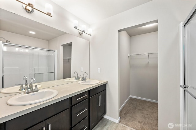 19504 15th Ave E, Spanaway, WA 98387 - bathroom featuring a walk in closet, double vanity, and an enclosed shower